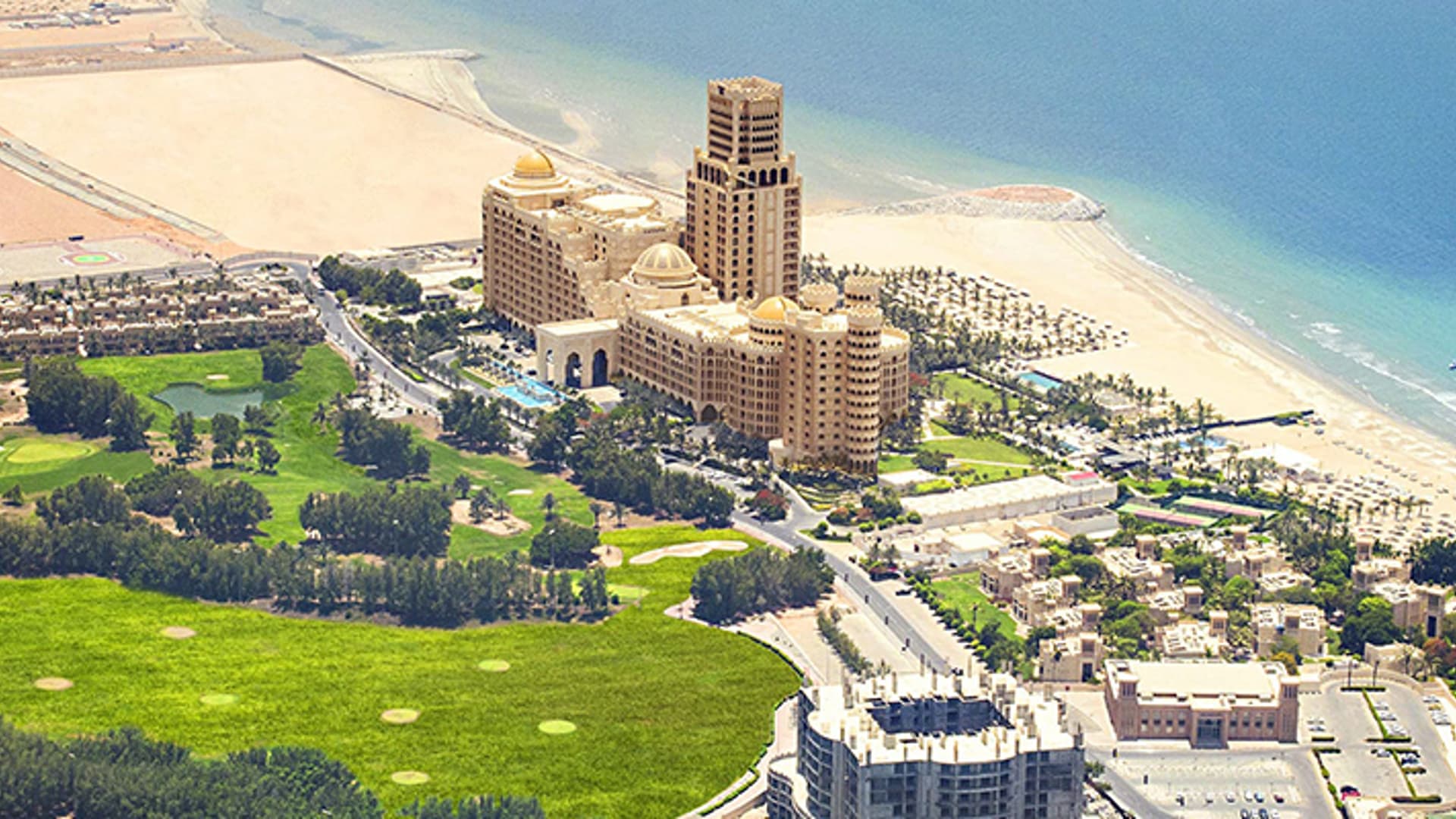 Aerial view across Al Hamra Village, its golf course and coast